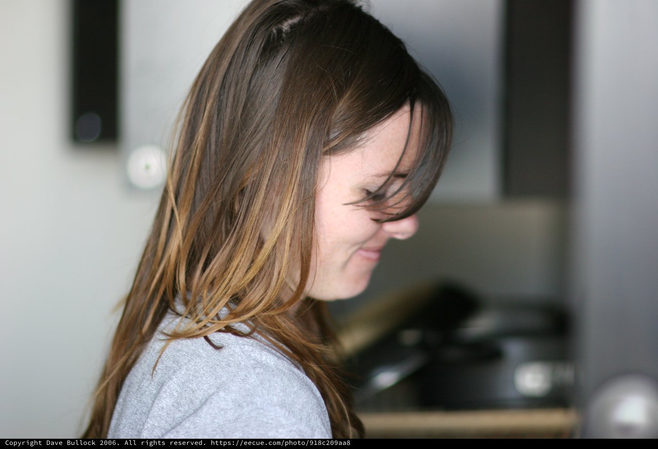Windswept Hair Cascading Over a Smiling Face