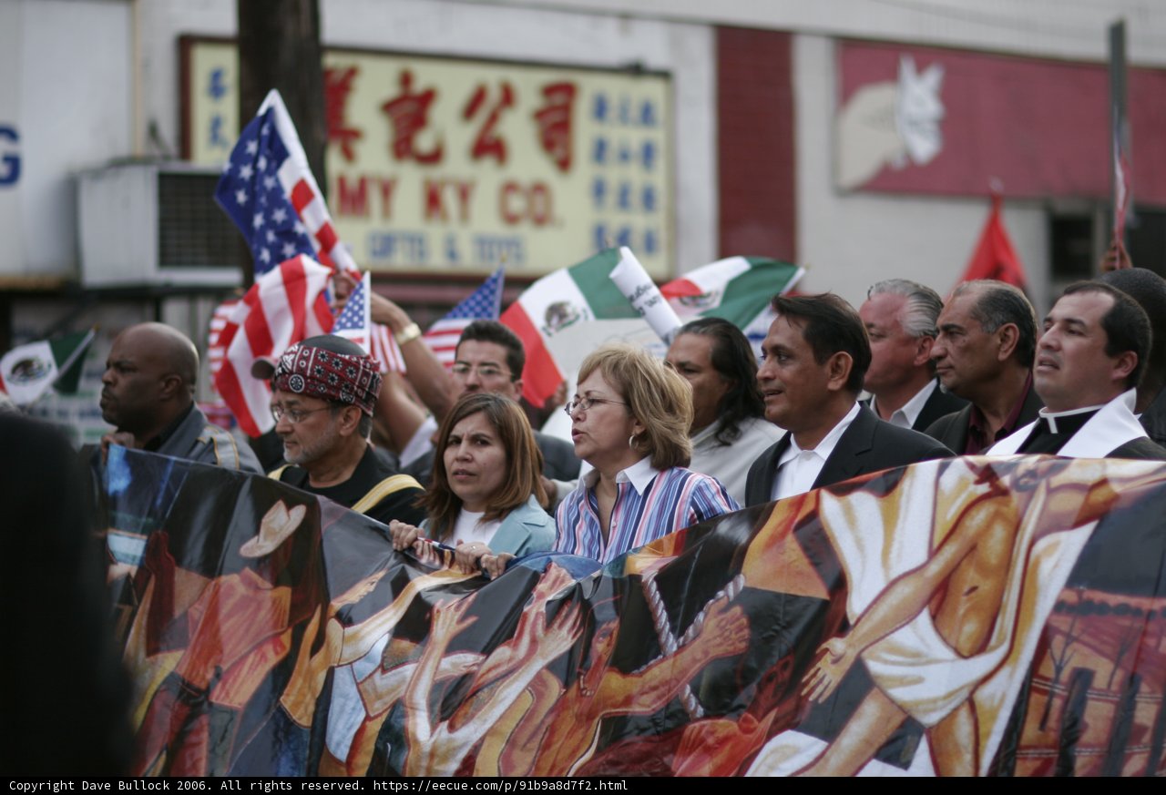 Parade Participants Hold Flags and Banners