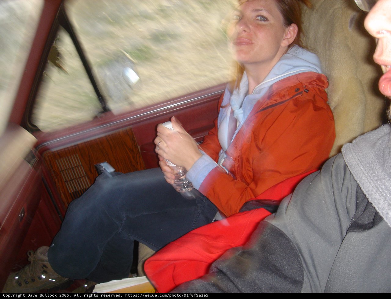 Woman in Red Jacket Riding in Vintage Vehicle