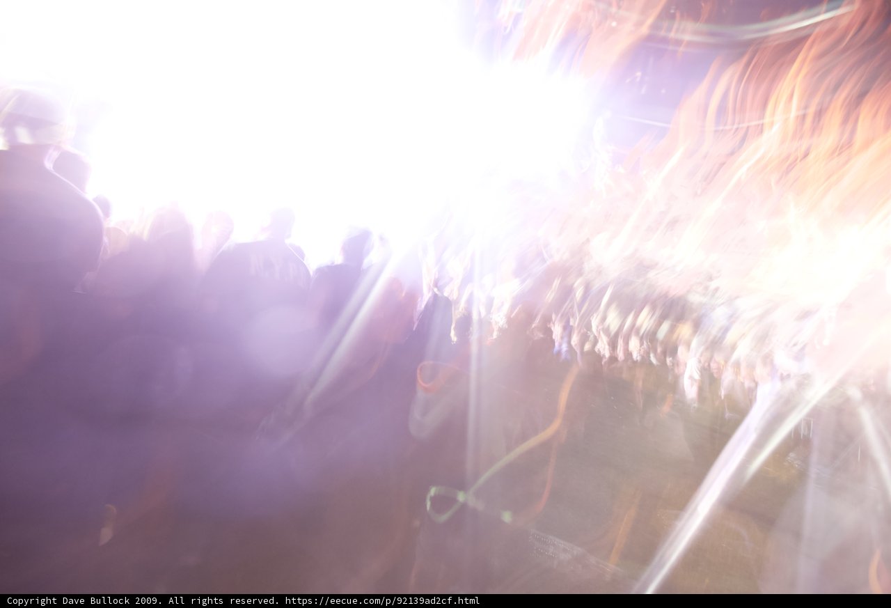 Blurry Nightlife at Coachella 2009 Caption: This photo captures the mesmerizing flare of the concert's lighting amidst the energetic crowd.