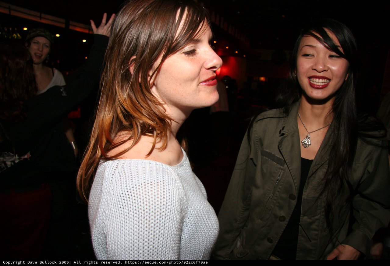 Two Women Smiling at a Nightclub Event 2006