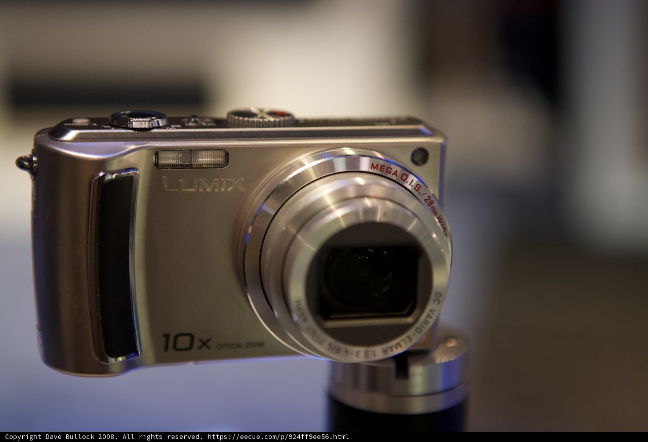 Shiny Silver Digital Camera on Stand