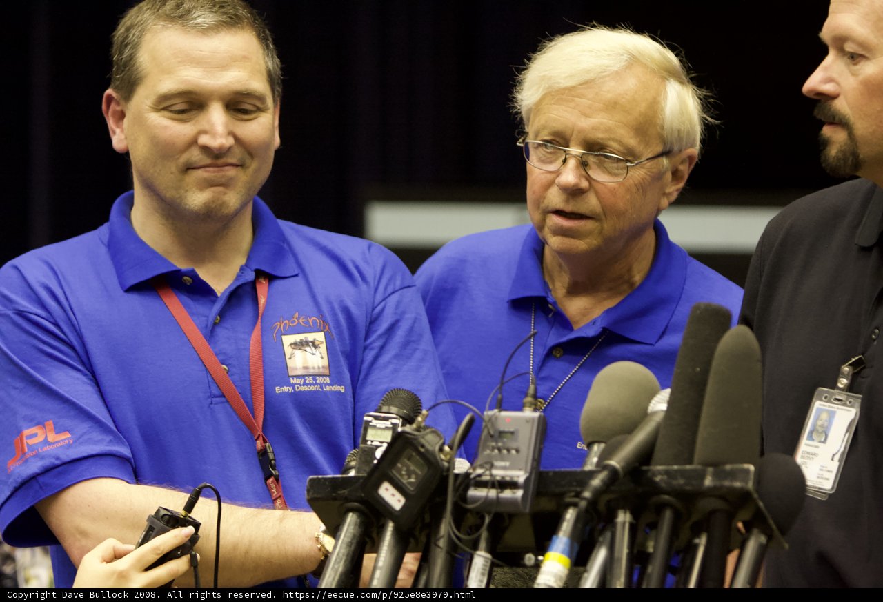 Press Conference with Three Men in Blue Shirts