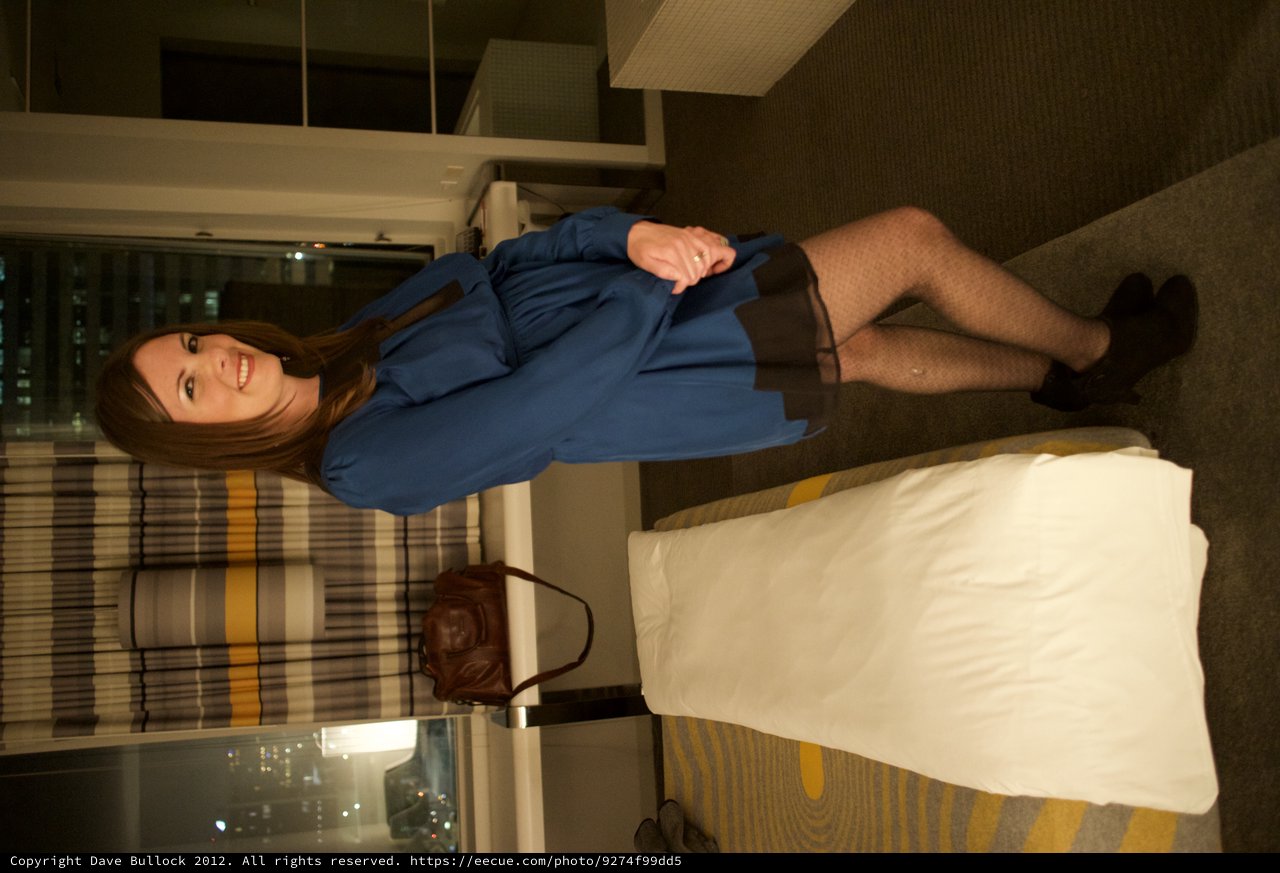 Woman in Blue Dress Posing in Modern Hotel Room