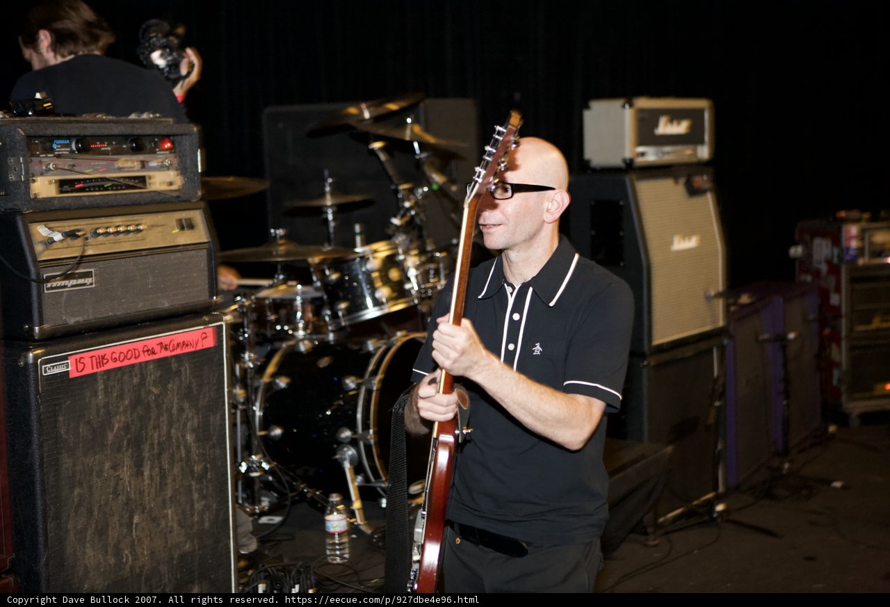 Man with Guitar Rocks Out on Stage