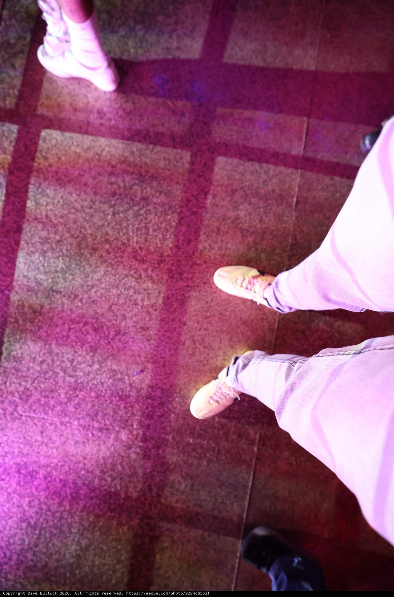 Looking Down at Sneakers on Dance Floor Carpet