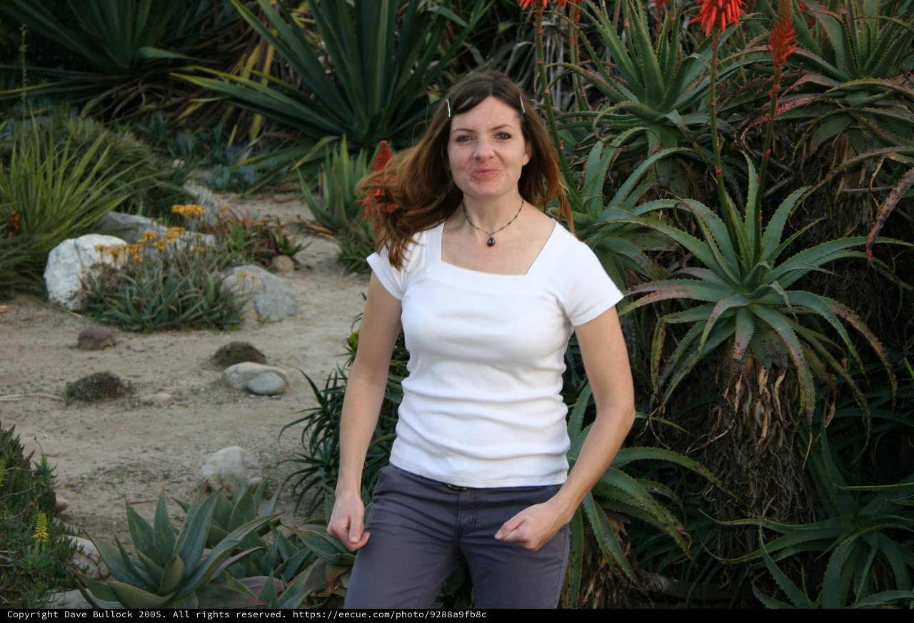 Woman Posing Among Desert Succulents and Aloe Plants