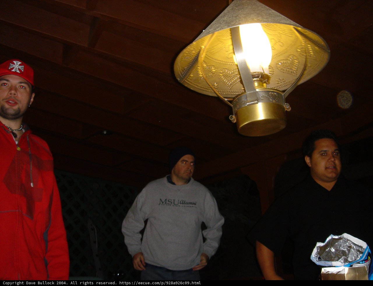 Red Shirted Man under Lamp Light