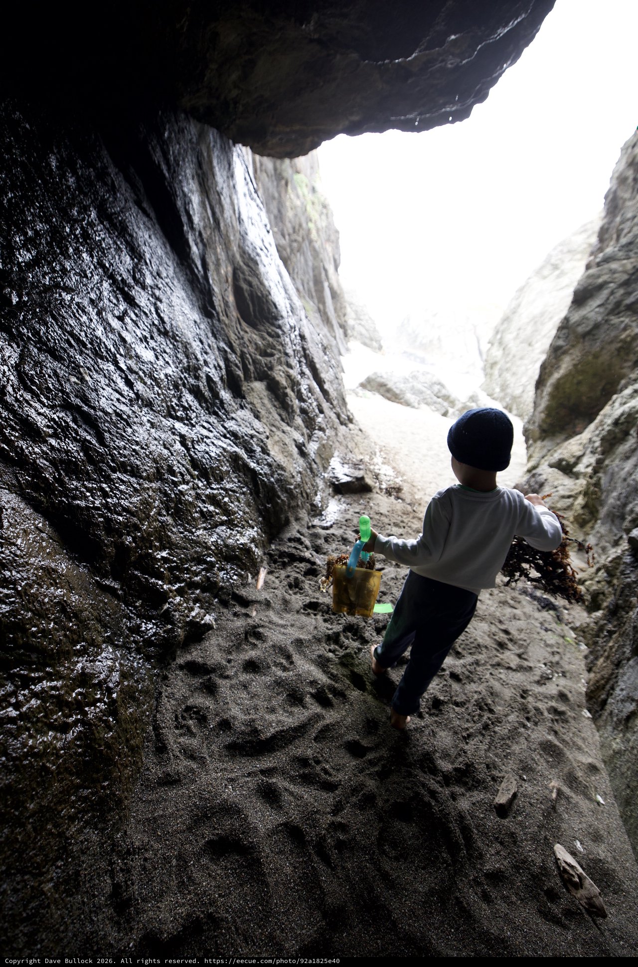 Young Explorer Ventures Through Sea Cave Passage