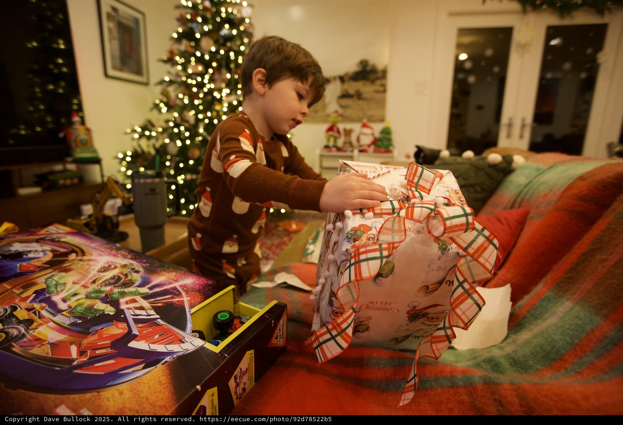 Child Unwrapping Christmas Presents on Christmas Morning