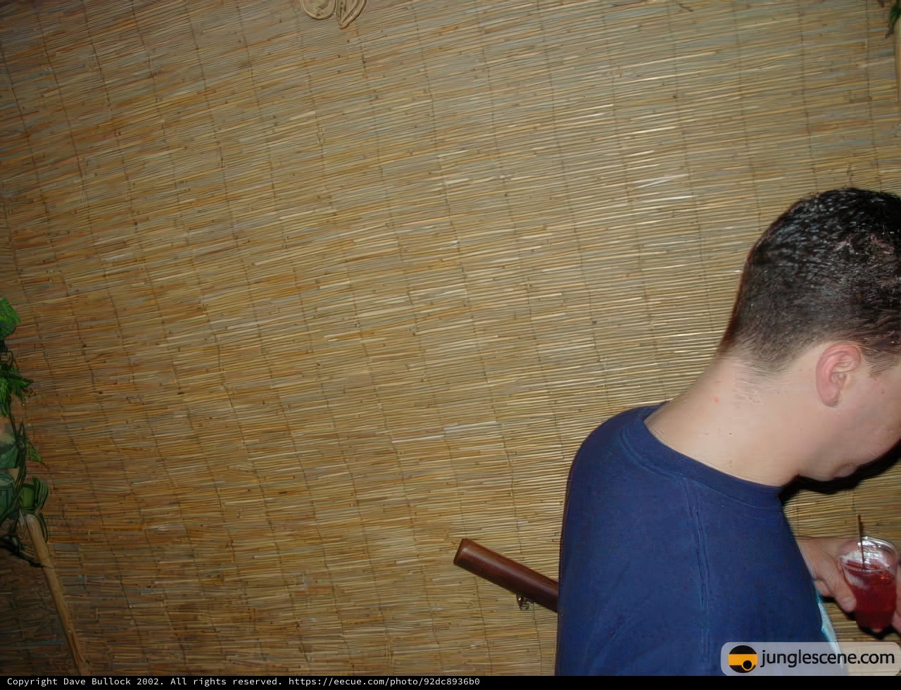 Man Stands Tall in Front of Inviting Bamboo Wall