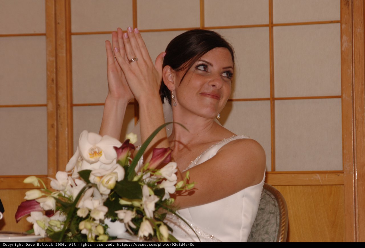 Bride Clapping Joyfully at Wedding Reception