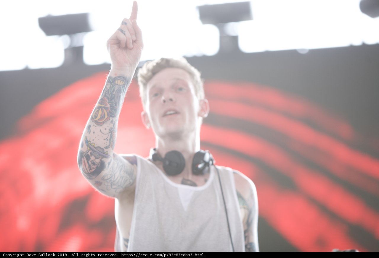 Tattooed Man Points Finger in Crowd at Coachella Concert
