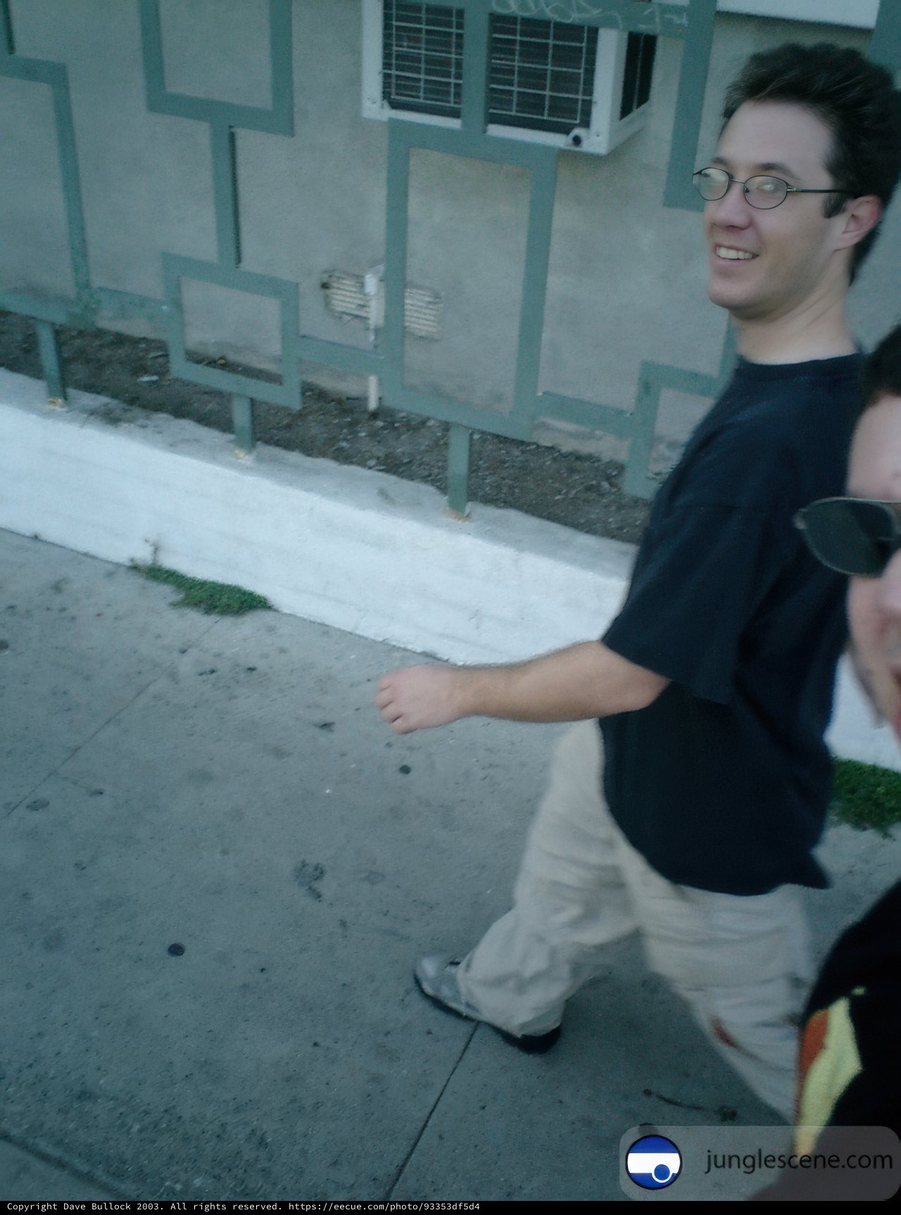 Two Men Walking Along the Sidewalk