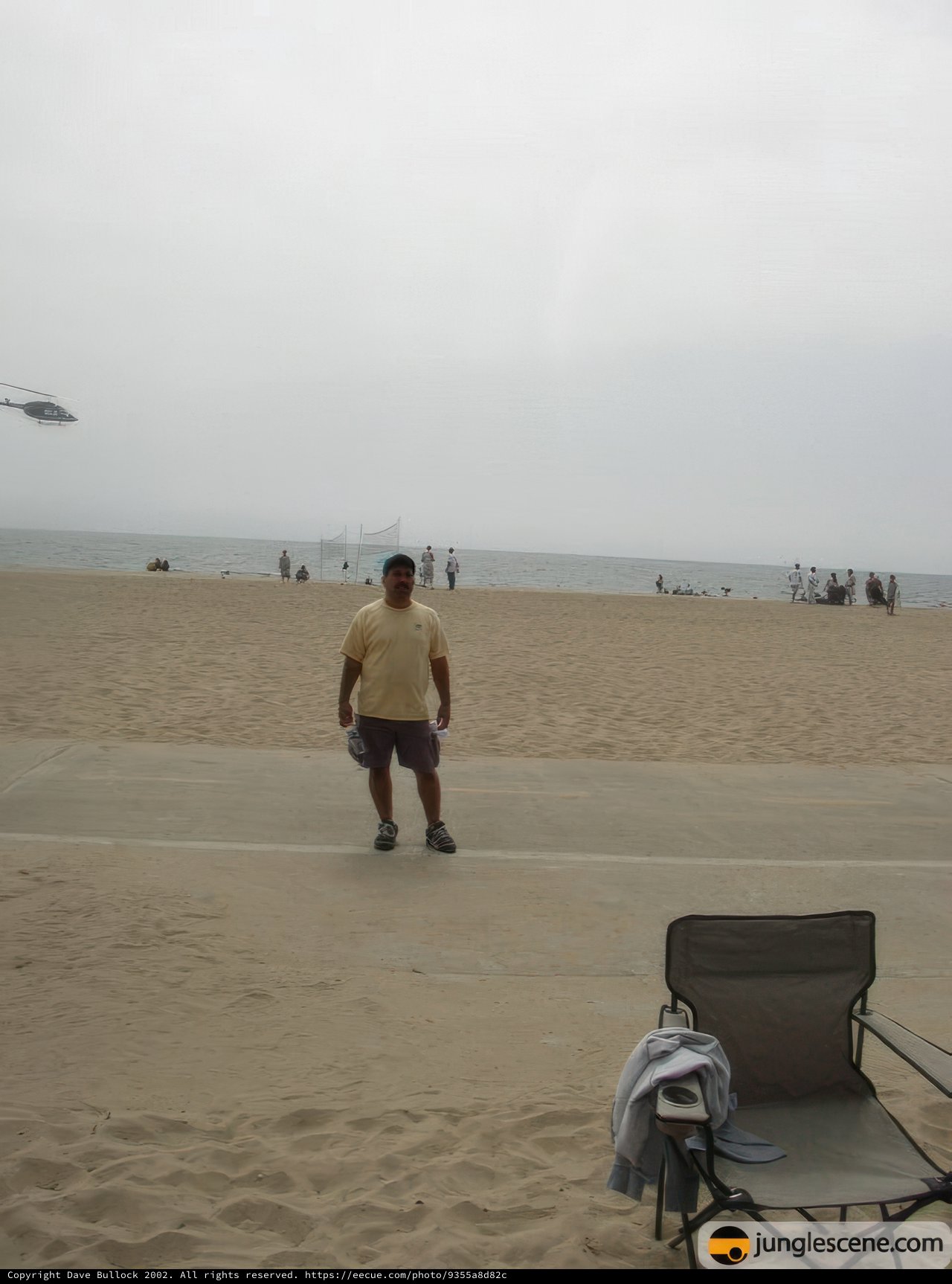 Walking on the Beach with a Helicopter and a Chair