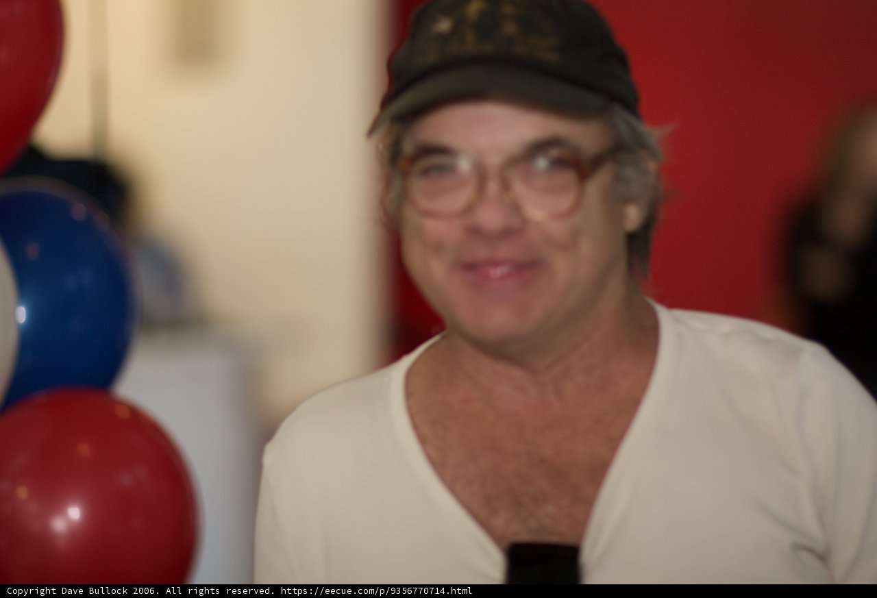 Man with Glasses and Cap Among Balloons