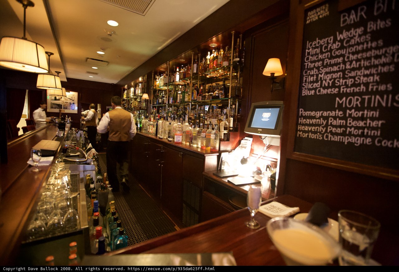 Four Patrons Enjoying Drinks at Chalkboard Bar