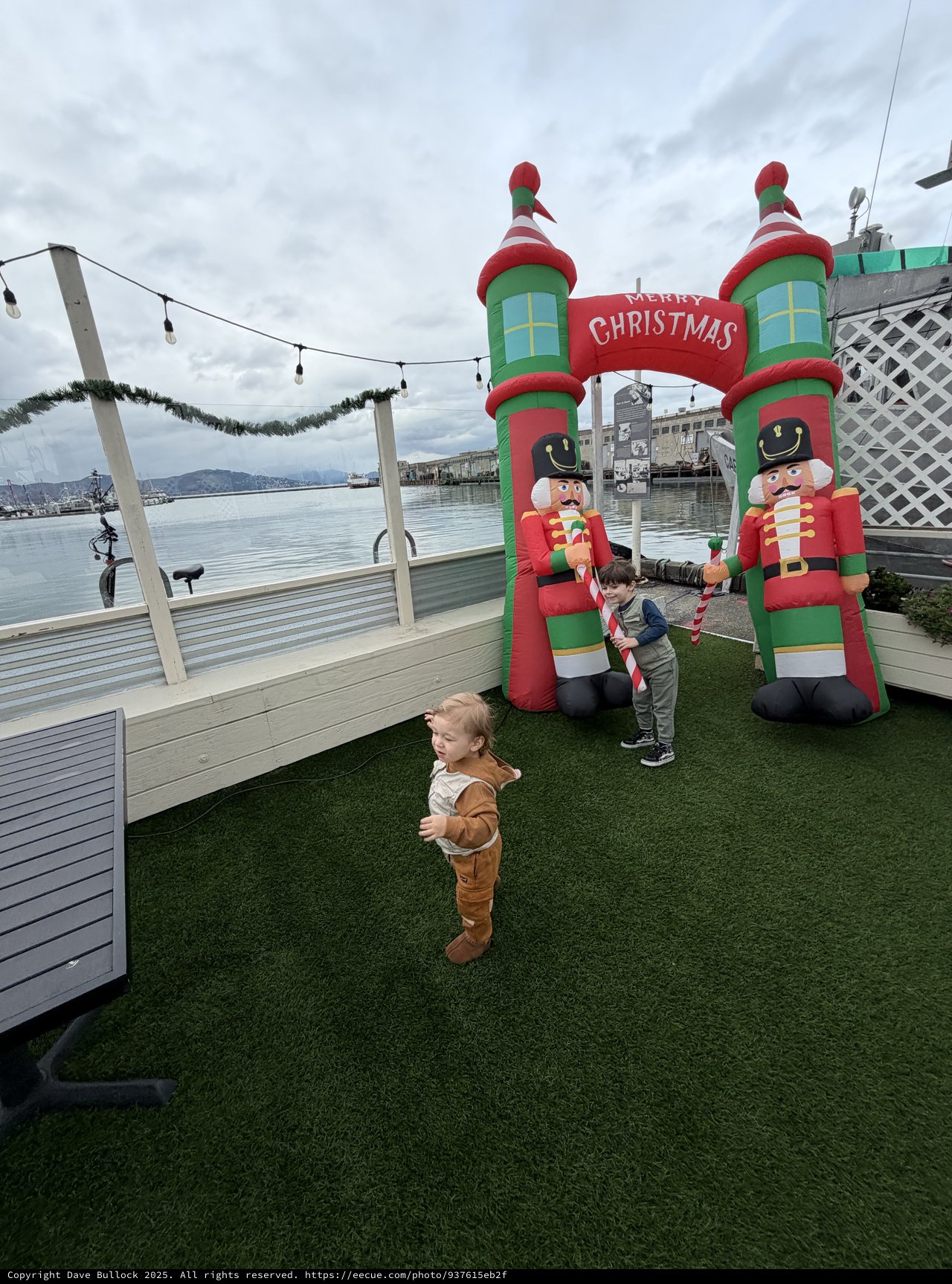 Children Playing by Christmas Inflatable Display at Waterfront
