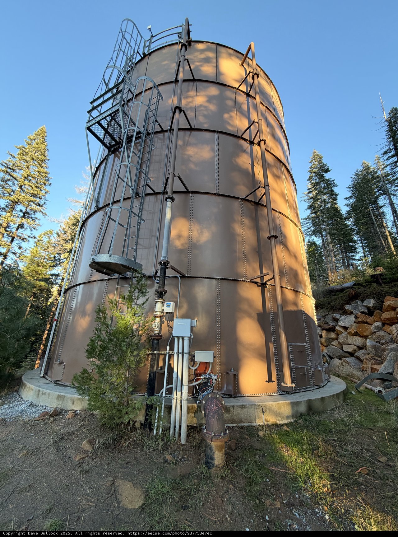 Industrial Steel Water Tank in Mountain Forest Setting