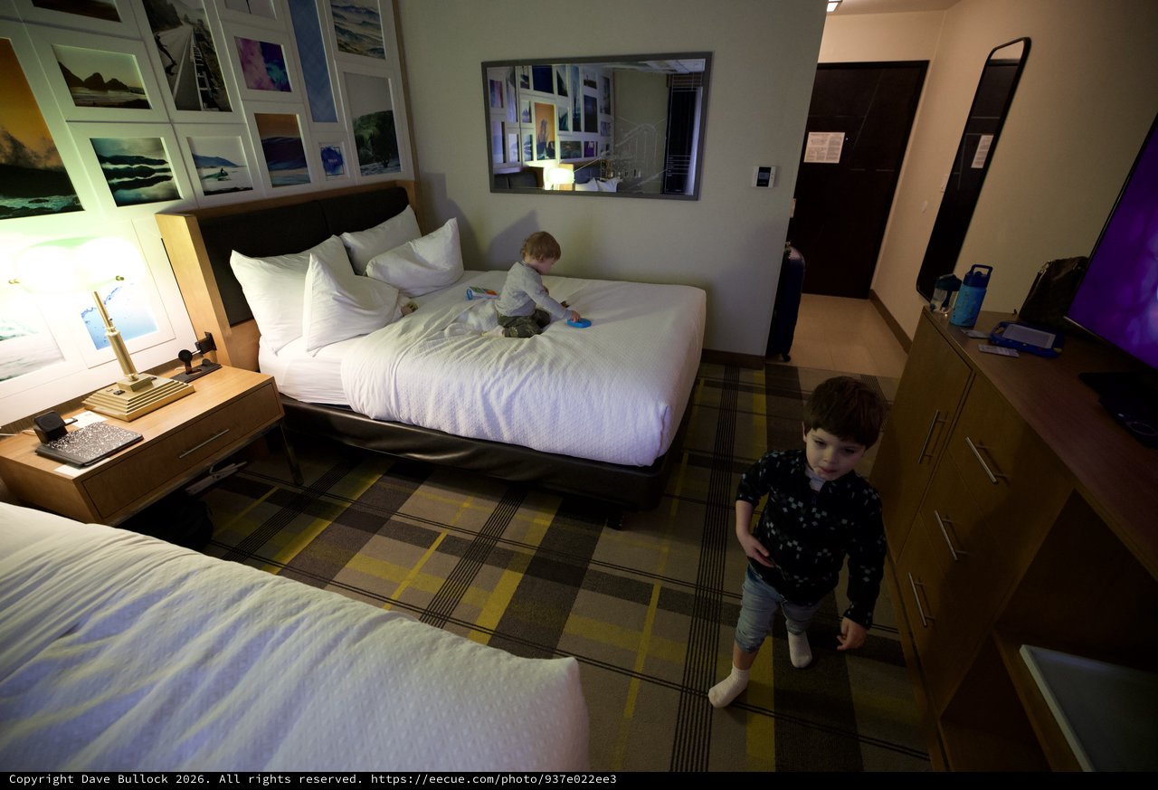 Two Young Children Playing in Modern Hotel Room