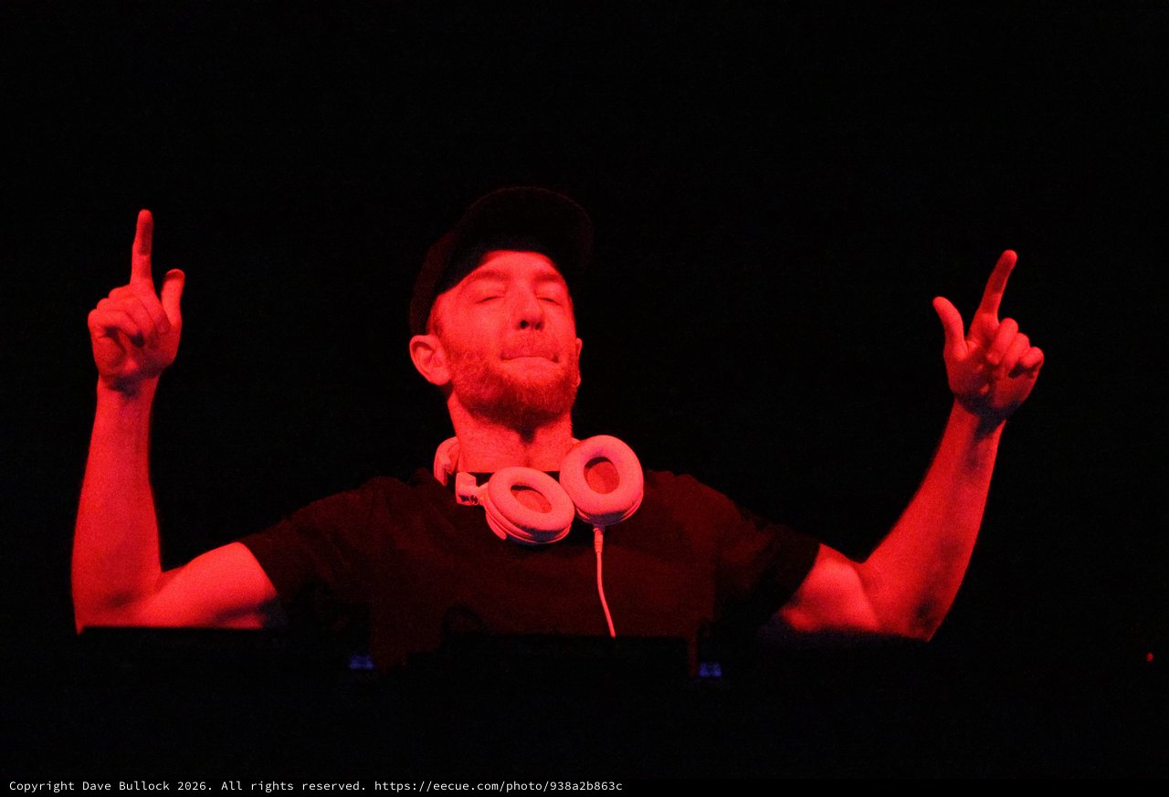 DJ Lost in the Music Under Red Lights