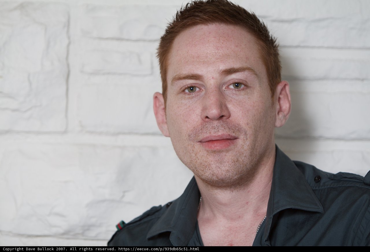 Smiling Man in Black Shirt