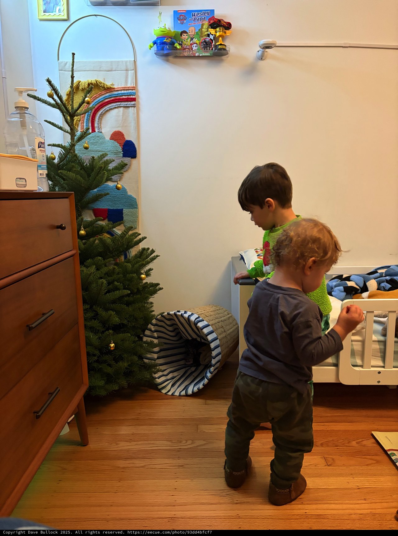 Two Young Children Exploring Their Christmas-Decorated Bedroom
