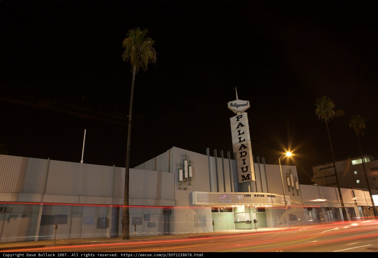 Nighttime View of City Theater with Palm Trees
