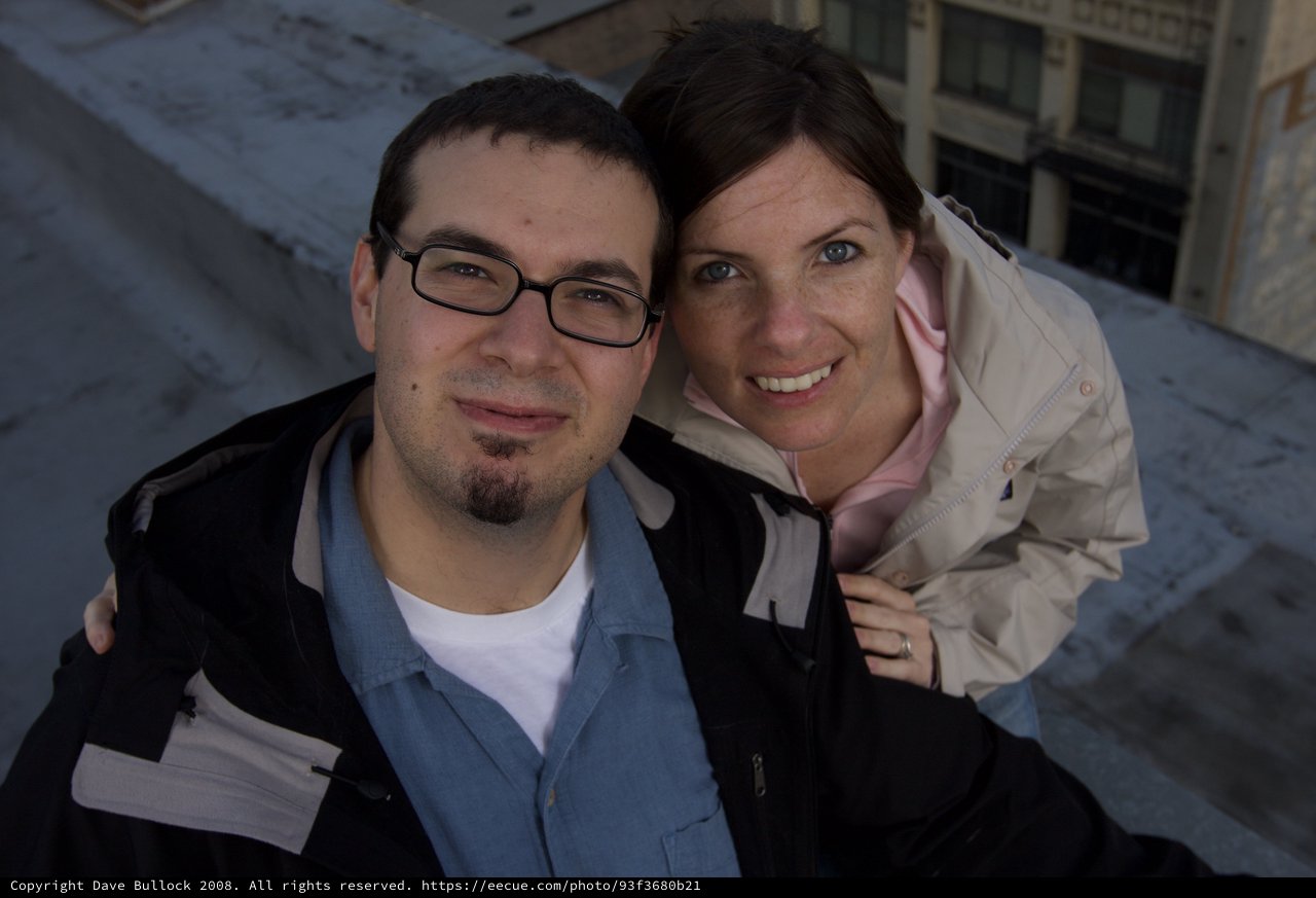 Dave and Penelope Smiling Atop Urban Rooftop