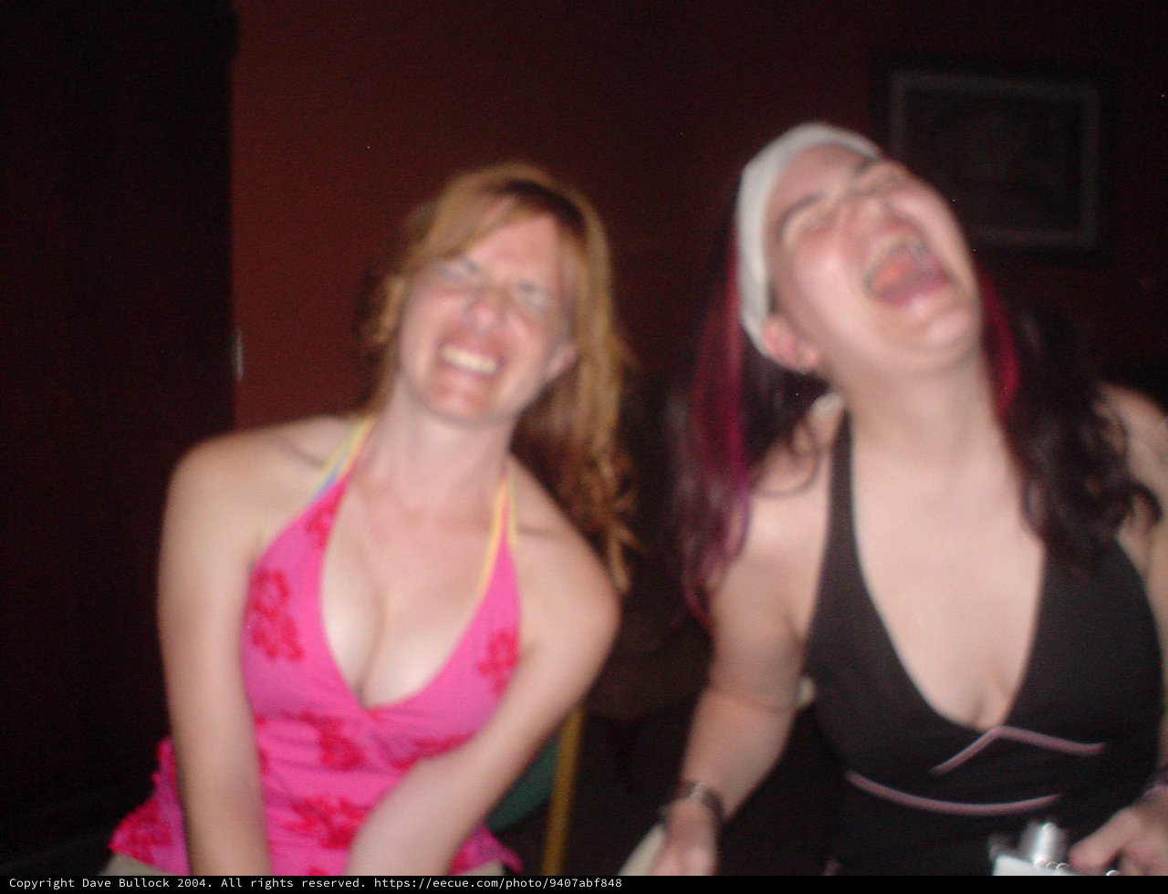 Two Women Laughing Joyfully at a Nightclub
