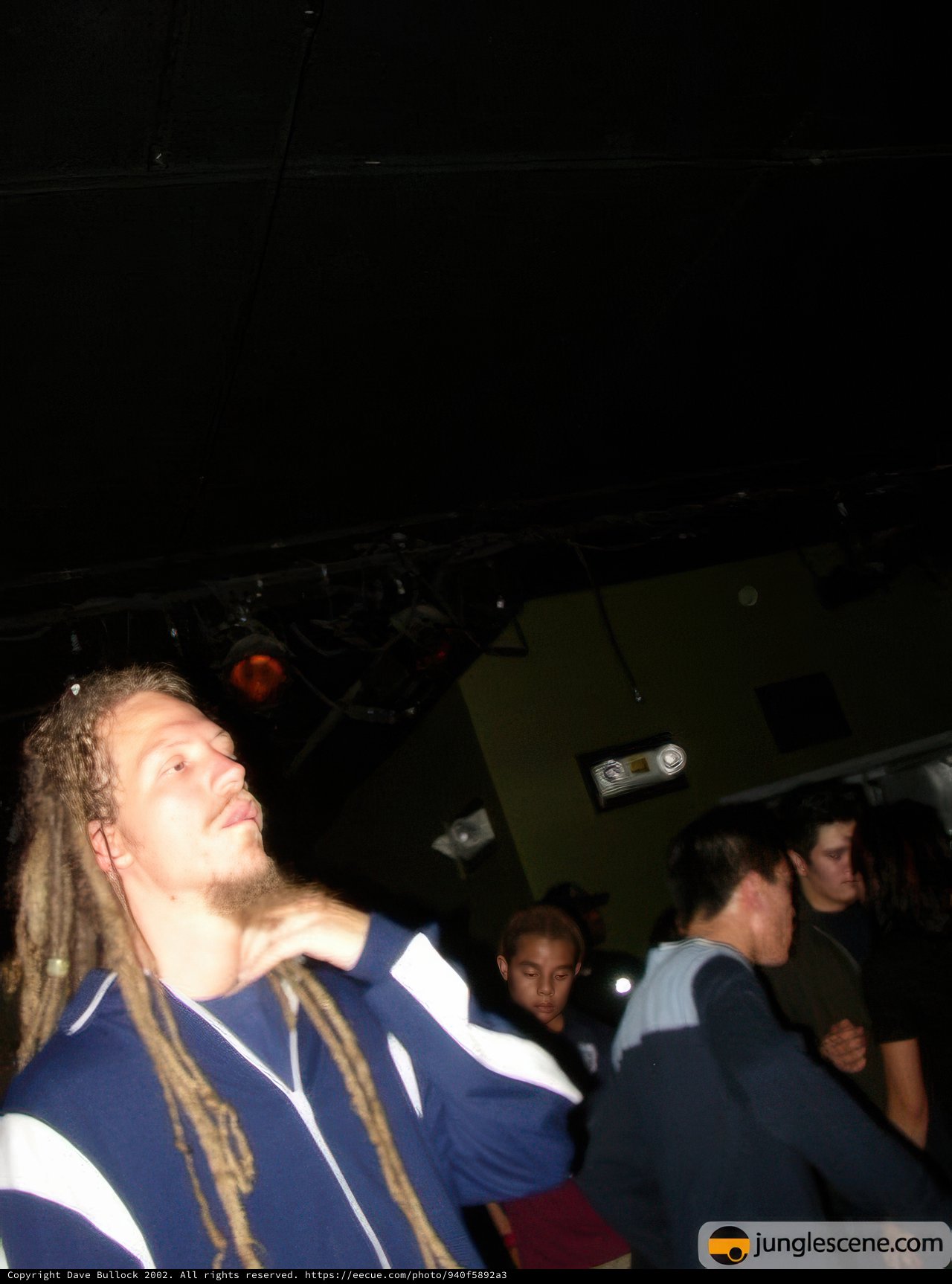 Dreadlocked Man Takes the Spotlight at Night Club