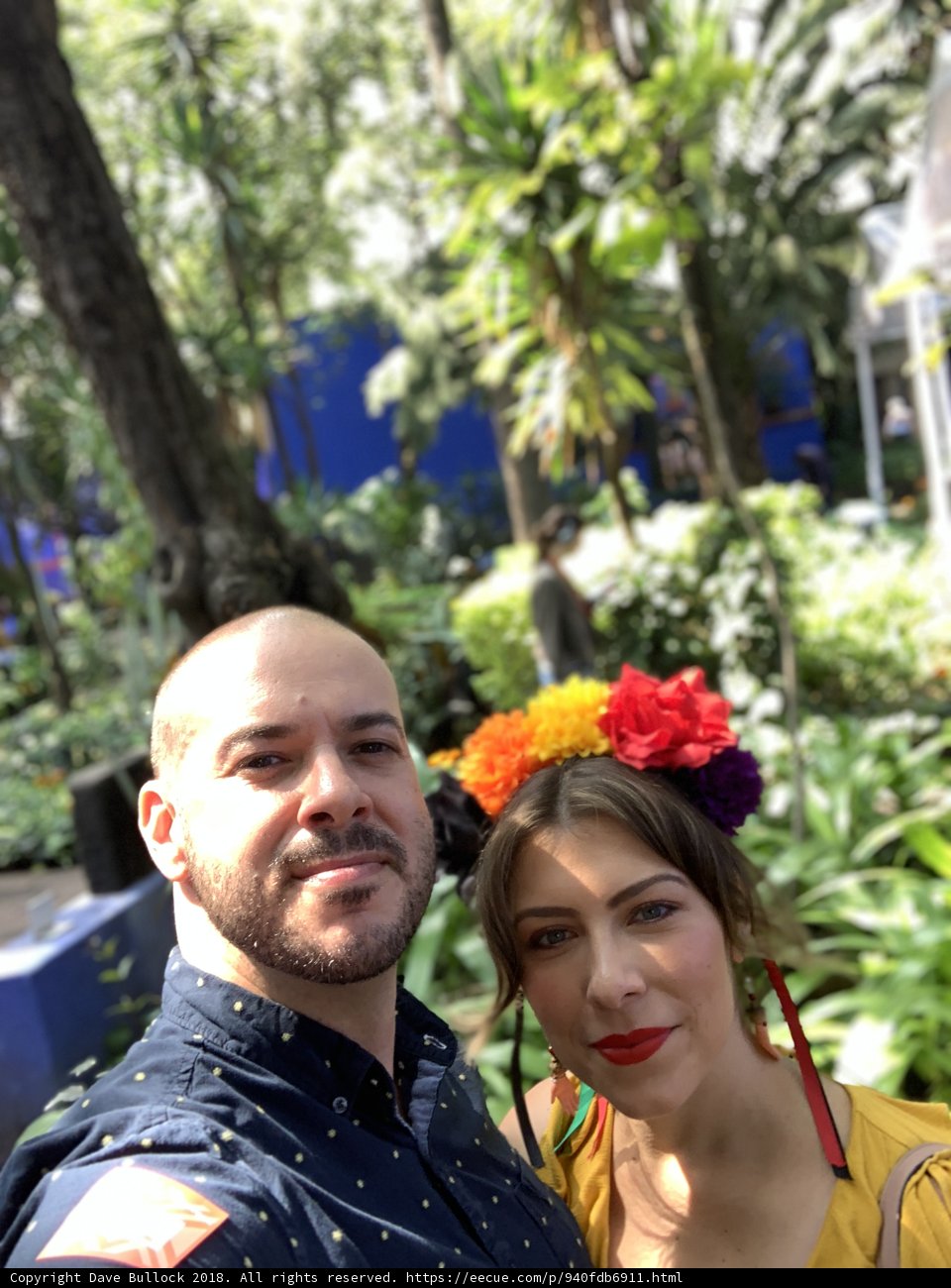 Smiling Couple Captures Moment in Garden Selfie