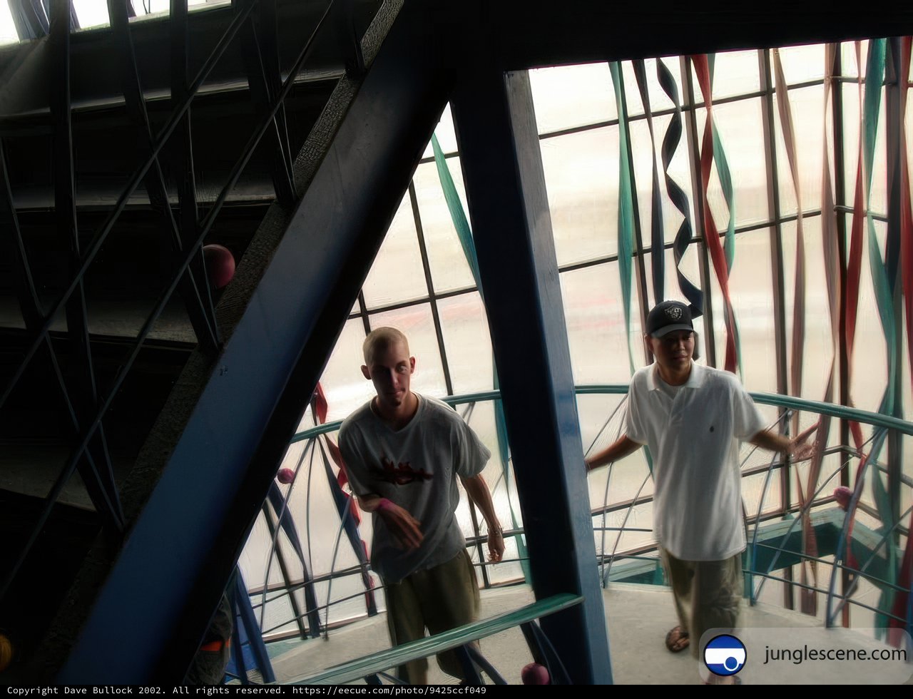 Two men posing on a staircase inside a building in Ensenada