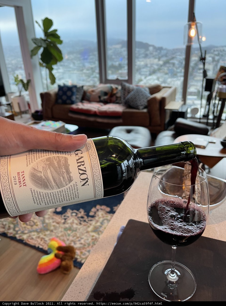 Pouring a Glass of Red Wine on an Outdoor Armchair