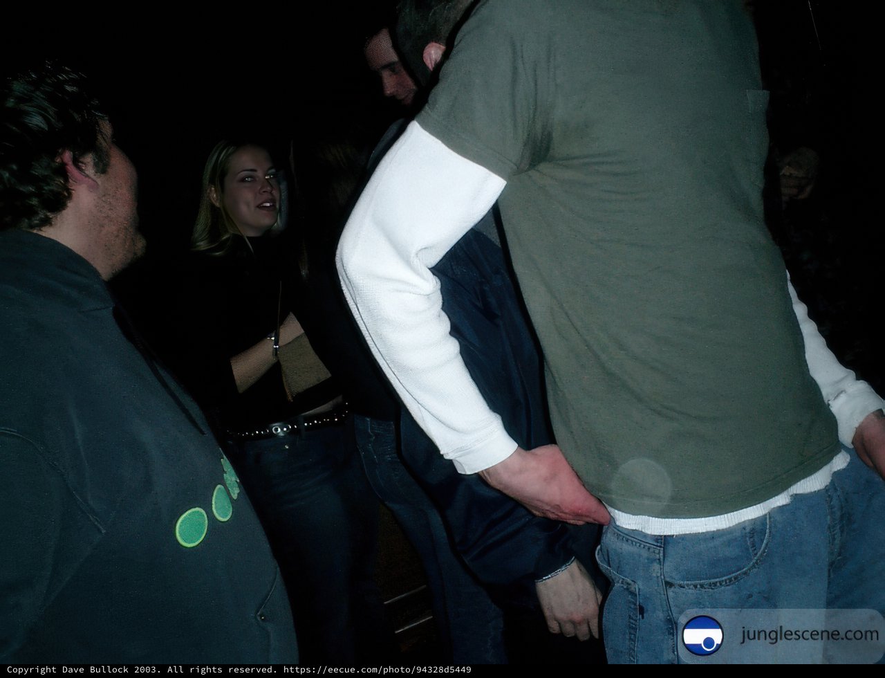 Man in Jeans Standing Before a Crowd