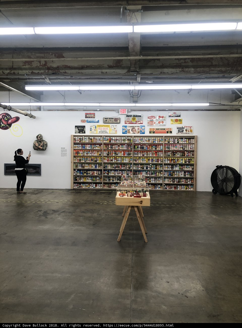 Man Standing Before a Shelf Full of Books