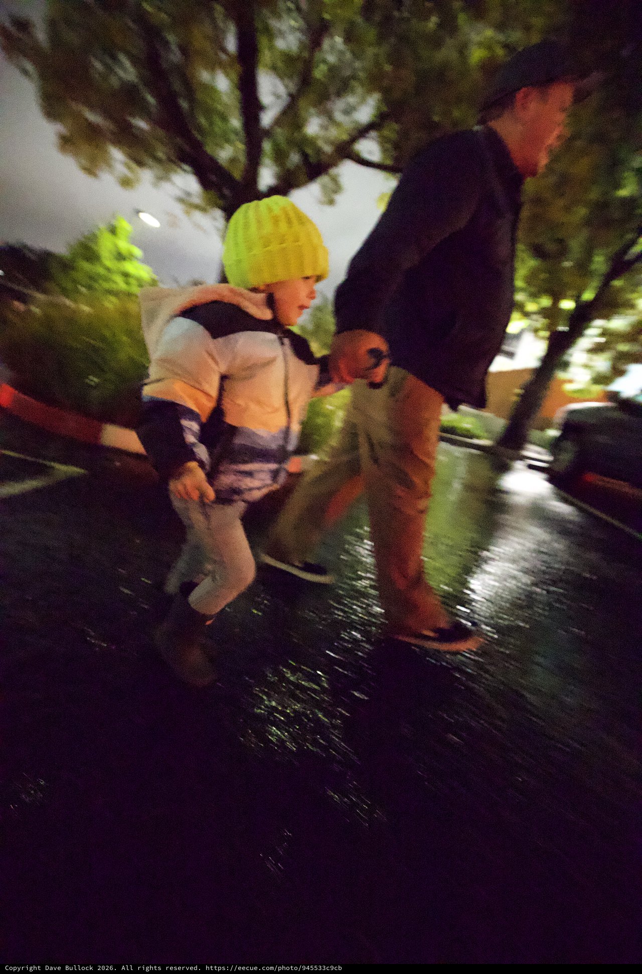 Night Rescue: Emergency Personnel Assisting Child in Yellow Hat