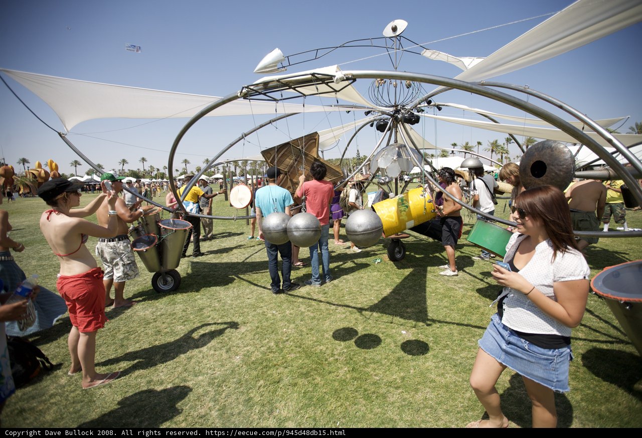 A Group Gathering Around A Metal Structure at Coachella