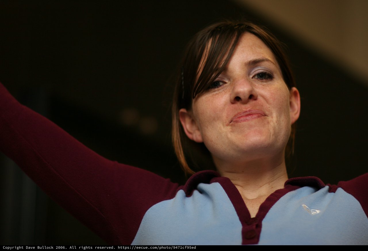 Woman in Aston Villa Kit Celebrates with Arms Raised