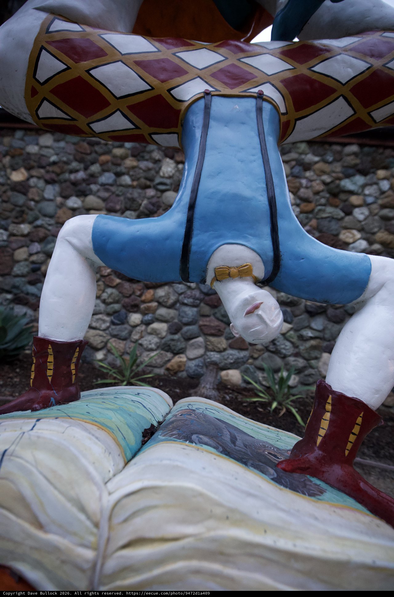 Headless Figure Installation at Stone Wall Backdrop