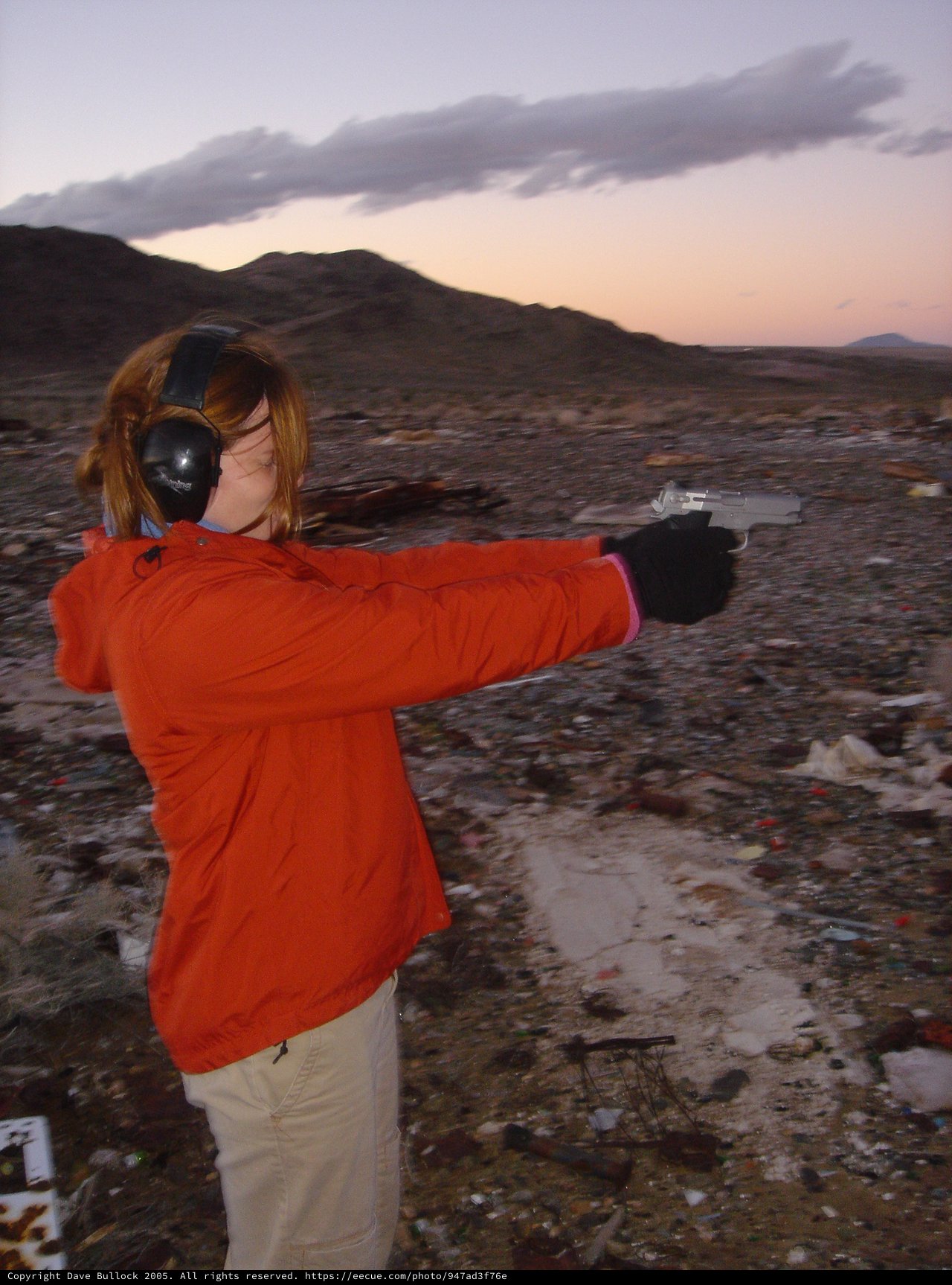 Woman Shooting Pistol at Desert Range at Dusk