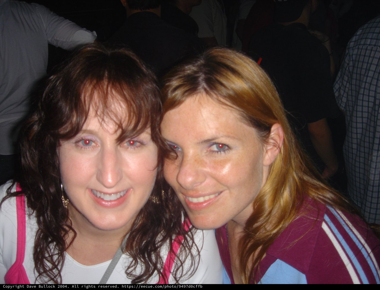 Two Friends Smiling Together at a Social Event