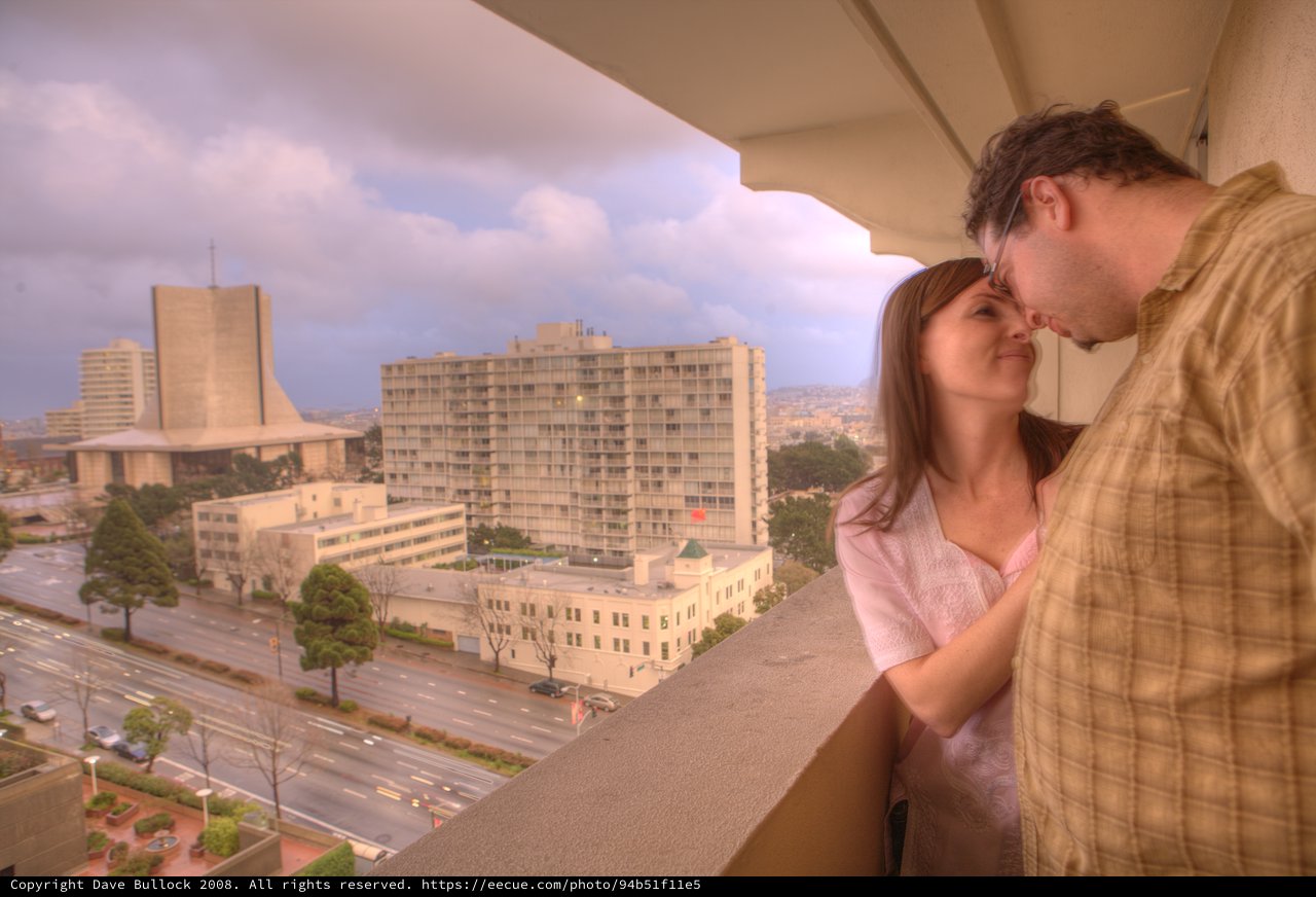 Romantic Balcony Moment Overlooking a City at Dusk