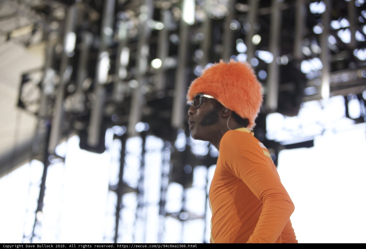 Man on Stage in Orange Hat and Beanie