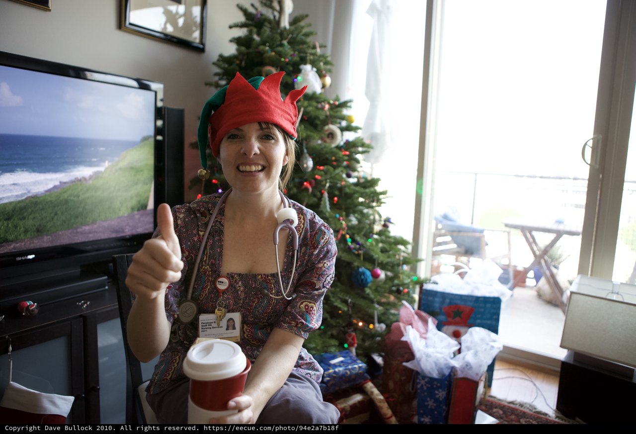 Festive Nurse Elf Celebrates Christmas with Thumbs Up