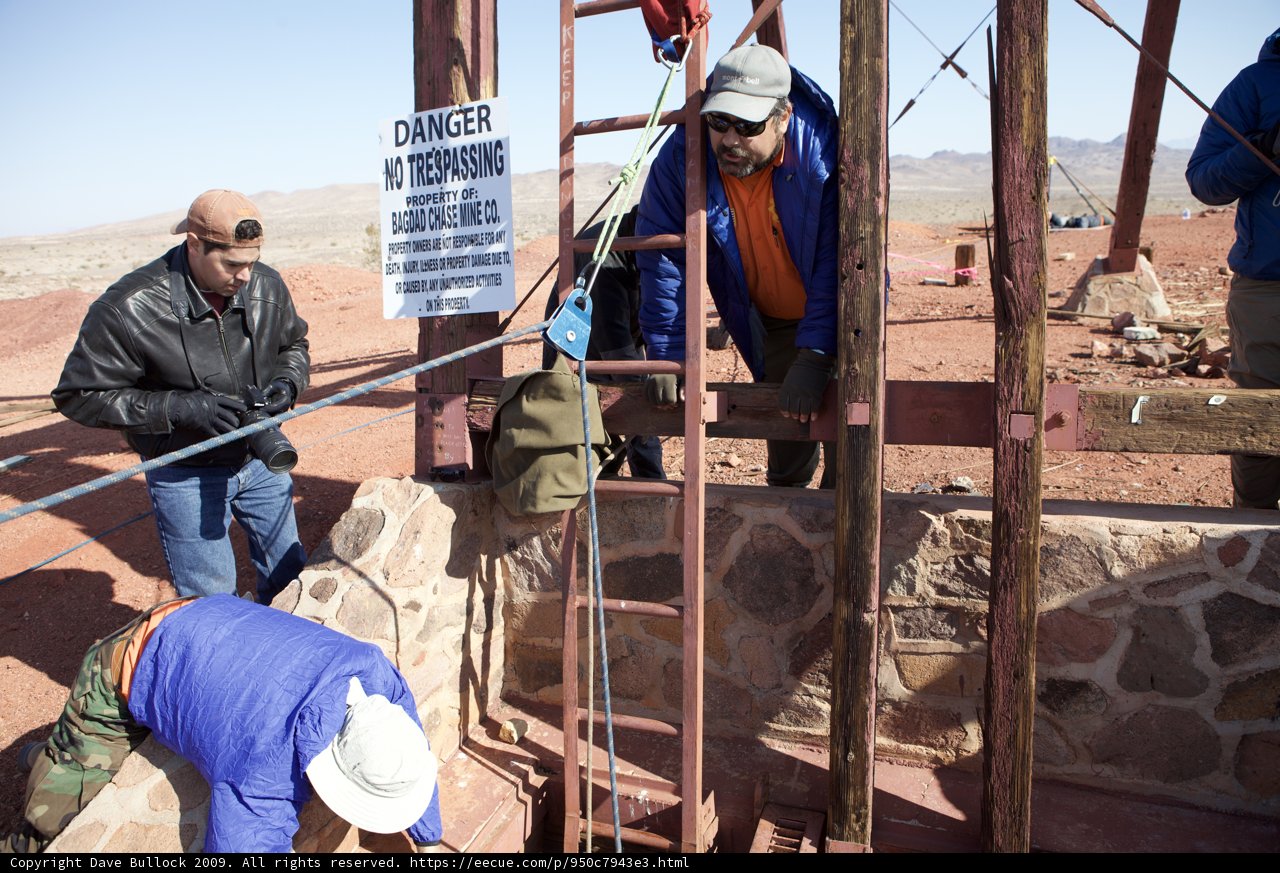 Three Workers Repair Walkway in Desert