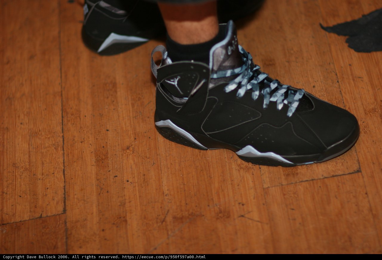 Black and Silver Sneakers on Hardwood