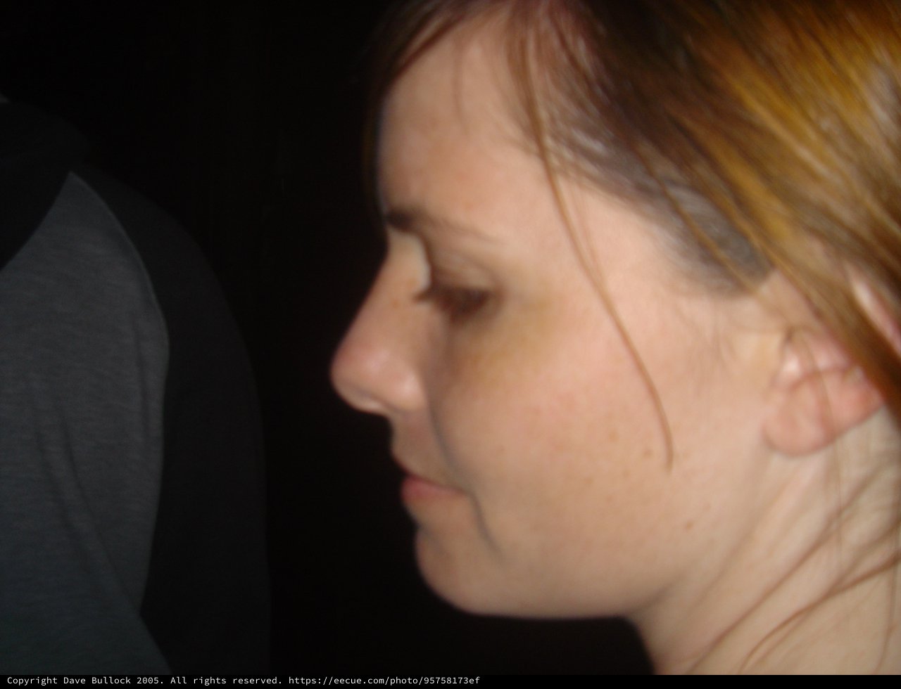Side Profile Portrait of Woman in Dark Setting
