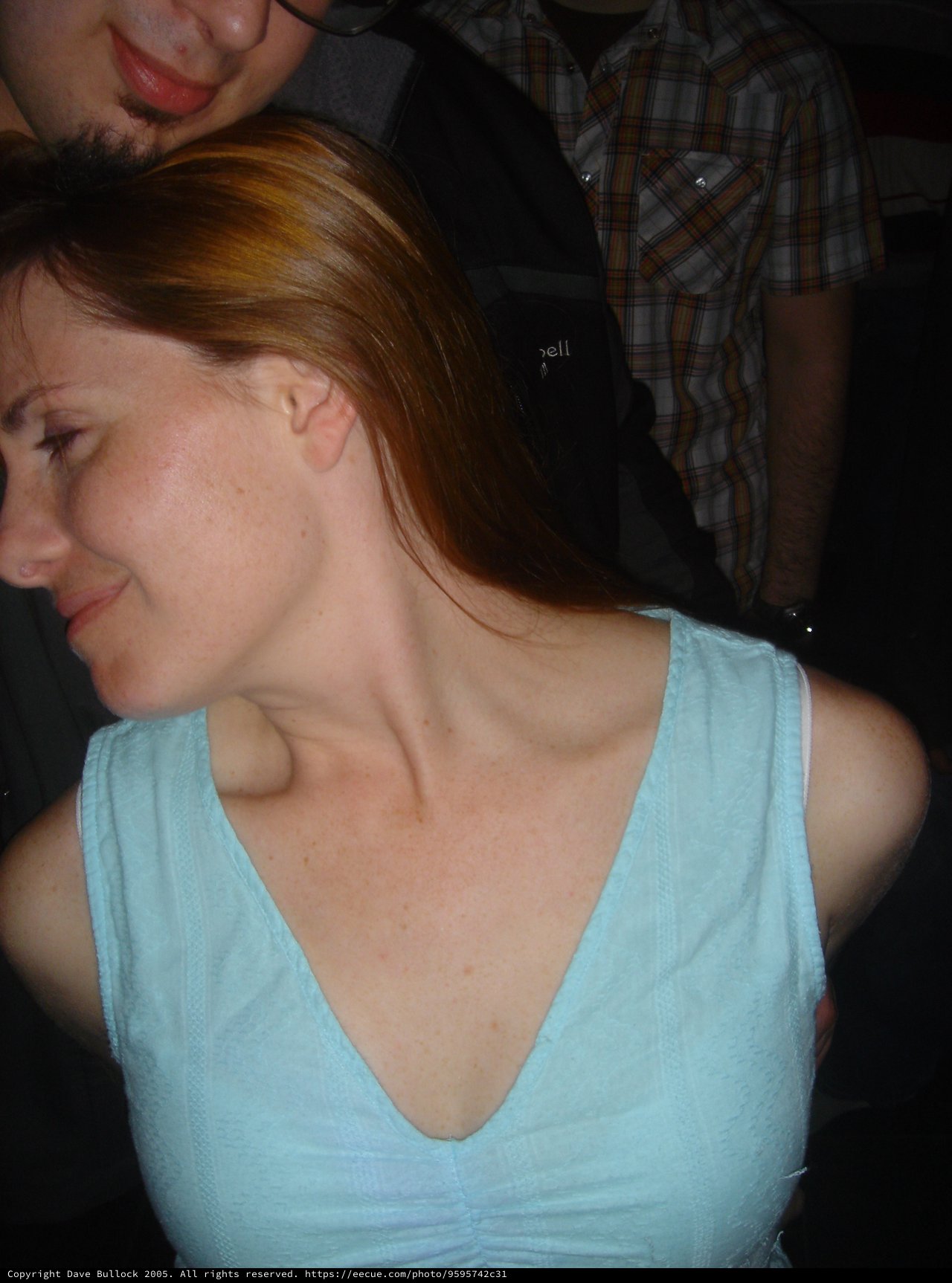Red-Haired Woman in Light Blue Top at Party