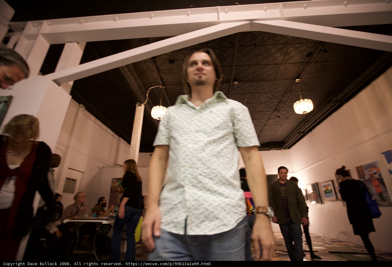 Art Enthusiast Admires Paintings in Gallery